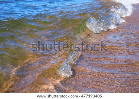clean water in lake. Small waves, sandy bottom