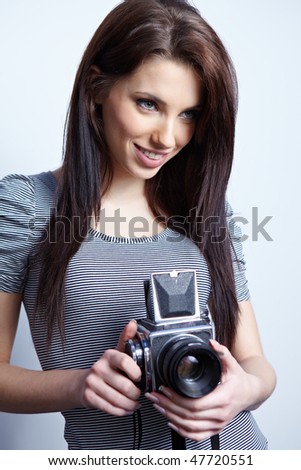 Young beautiful woman with camera