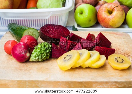 Organic fruits and vegetables fresh. Placed on a wooden cutting board .Organic concept of eating healthy.