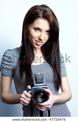 Young beautiful woman with camera