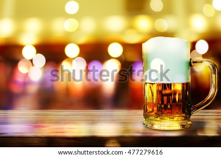 Beer in glass on wooden table,Christmas light background