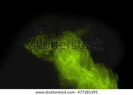 Explosion of green powder on black background