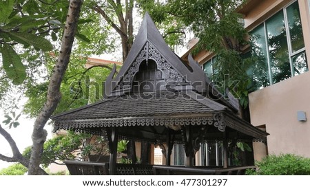 A wooden Thai style pavilion isolated in the garden