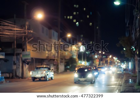 Abstract blurred of bokeh lights at night on road with car.