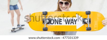 Attractive skater girl holding her yellow skateboard, skater in the background, banner photo