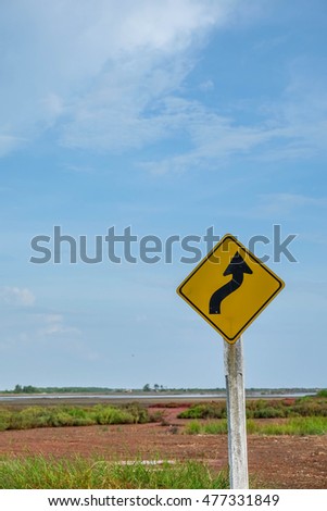 yellow arrow sign in the rural country field with blue sky blank for text in thailand
