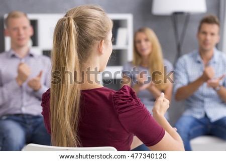 Young woman showing an address hand gesture during a sign language classes