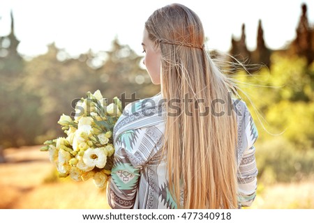 Boho hairstyle. Beautiful hippie girl outdoors at sunset. Boho fashion style, series