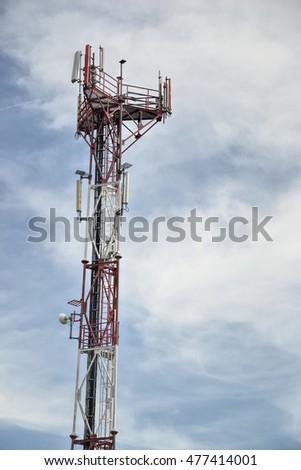 Base transceiver station (BTS) with antenna isolated on blue sky background. Telecommunications radio tower cells 
