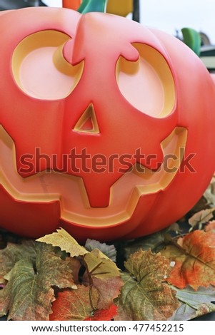 Halloween decorations concept.Close up of Jack O'lantern, vintage lanterns, pumpkins, skull, autumn leaves. Colorful Halloween. Happy Halloween scene background