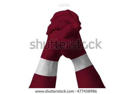 Man clasped hands patterned with the LATVIA flag