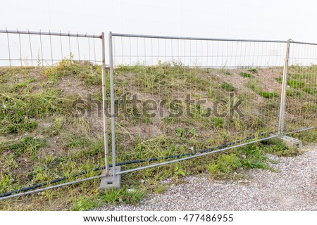 Construction site fence Royalty-Free Stock Photo #477486955
