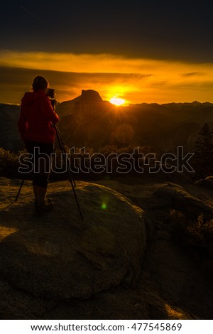 Yosemite National Park Woman Photographer taking pictures at Sunrise from the Glacier Point