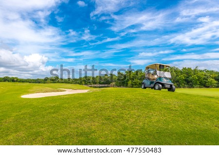 Sand bunkers and a golf cart at the golf course.