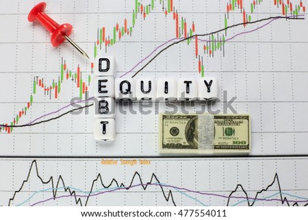 Debt-Equity written on white cube with candlestick chart background. Conceptual image for D/E ratio.