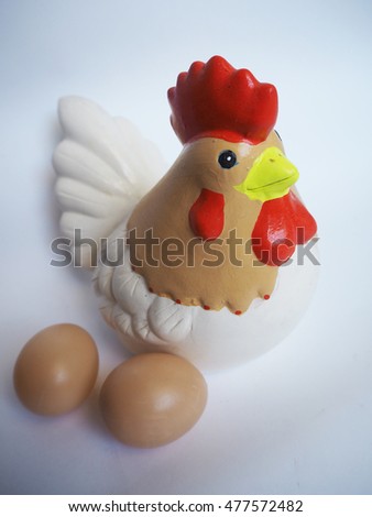 Hen and its eggs on isolated background.