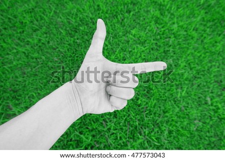 hand sign on green background.