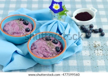 vegan blueberry smoothie bowl with chia seeds and acai powder