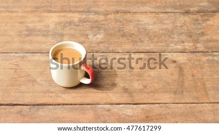 Hot coffee on old wooden plank
