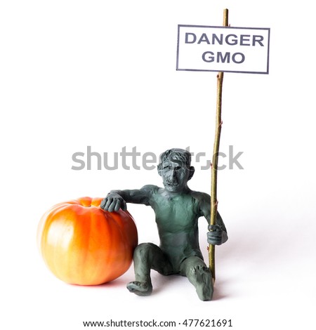 GMO concept danger figure of a man holding a poster