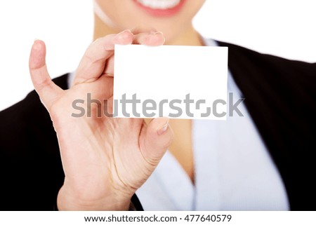 Young business woman holding small empty paper card 