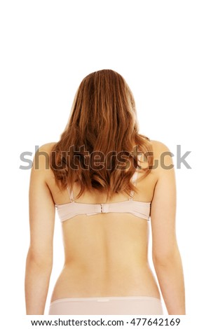 Rear view of young woman in beige underwear 
