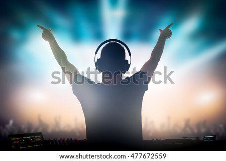 Charismatic disc jockey. Club, disco DJ playing and mixing music for crowd people. Royalty-Free Stock Photo #477672559