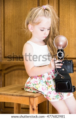 little girl in home with camera