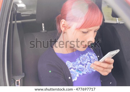 girl with pink hair viewing pictures on the screen of your smartphone