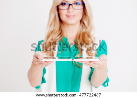 Portrait of young confident business lady, use the tablet, white background
