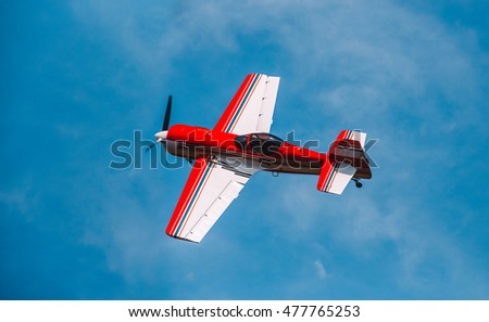 Flying in the sky, on a background of clouds, the plane  Royalty-Free Stock Photo #477765253