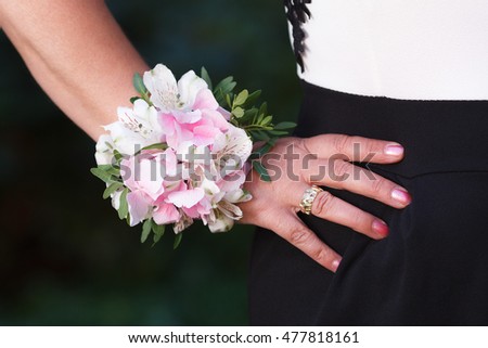 Wrist corsage of hydrangea and alstroemeria flowers on a hand