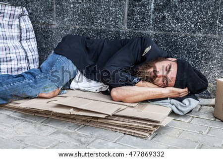 Vagrant sleeping outside Royalty-Free Stock Photo #477869332