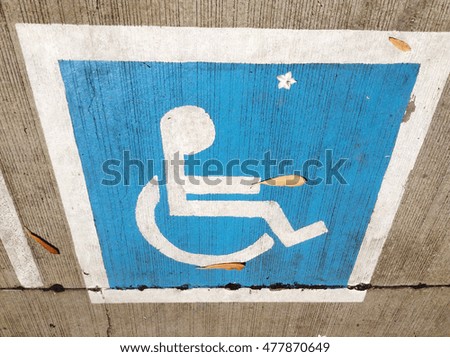 Handicap parking  symbol painted on the parking lot