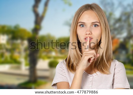 picture of teenage girl with finger on lips