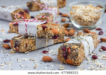 Homemade granola energy bars with figs, oatmeal, almond, dry cranberry, chia and sunflower seeds, healthy snack Royalty-Free Stock Photo #477888352