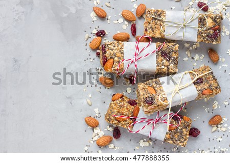 Homemade granola energy bars with figs, oatmeal, almond, dry cranberry, chia and sunflower seeds, healthy snack, top view, copy space Royalty-Free Stock Photo #477888355