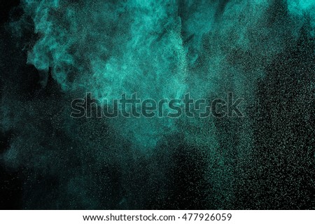 Aquamarine powder explosion on black background. Green  cloud. Colorful dust explode. Freeze motion paint  Holi.