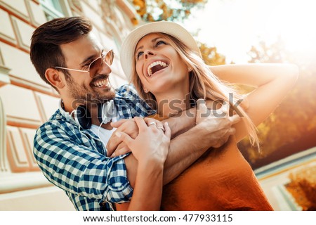 Smiling couple in love outdoors.Young happy couple hugging on the city street. Royalty-Free Stock Photo #477933115