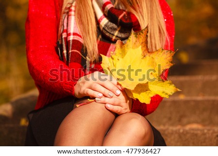 People outdoors concept. Lady with autumnal leaf. Close up picture of leaves in the park. 