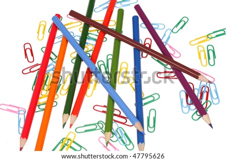 Multicolored pencils and office paper clips.. Isolated on a white background