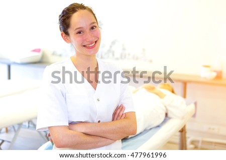 VIew of a young attractive masseuse in a professional room