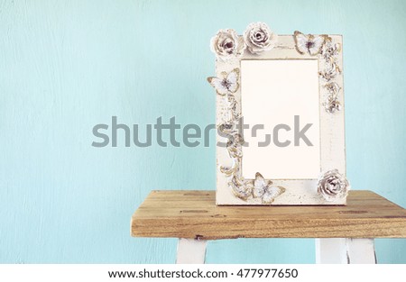 Image of vintage antique classical frame on wooden table. vintage filtered