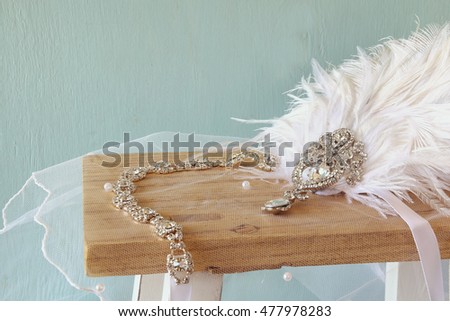 Image of gatsby style diamond head decoration with feathers on toilet table