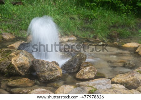 Artesian well. Eruption of spring, natural environment. Stones and water. Clean drinking groundwater erupting out of the ground. Norra Spring Area, Oostriku River, Endla Nature Reserv, Estonia, Europe Royalty-Free Stock Photo #477978826