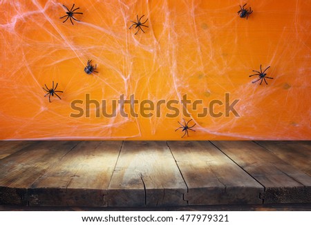 Halloween holiday concept. Empty rustic table in front of spider web background. Ready for product display montage
