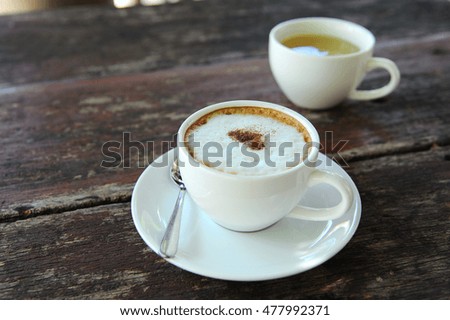 hot coffee cappuccino in cup on table (still life)