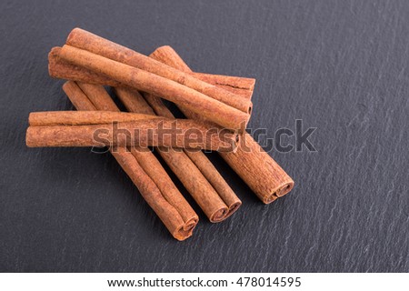 Cinnamon sticks on slate tile with faded effect
