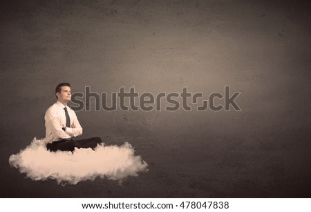 Caucasian businessman sitting on a white fluffy cloud wondering with a plain grunge background