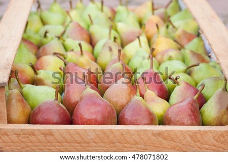 Pears in a wooden box as  background